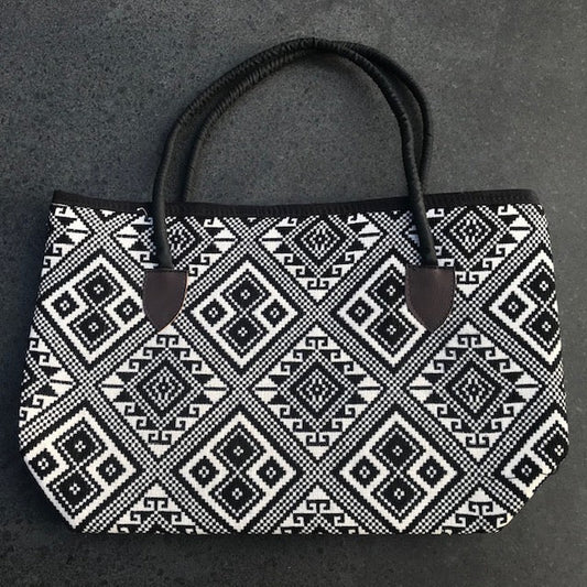 Schoudertas zwart wit geweven stof ritssluiting